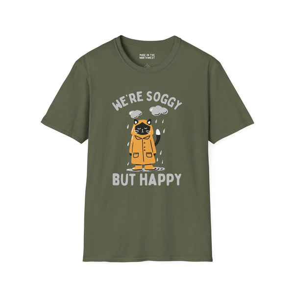 We're Soggy But Happy t-shirt featuring a drenched cat in a raincoat, perfect for Pacific Northwest lovers.