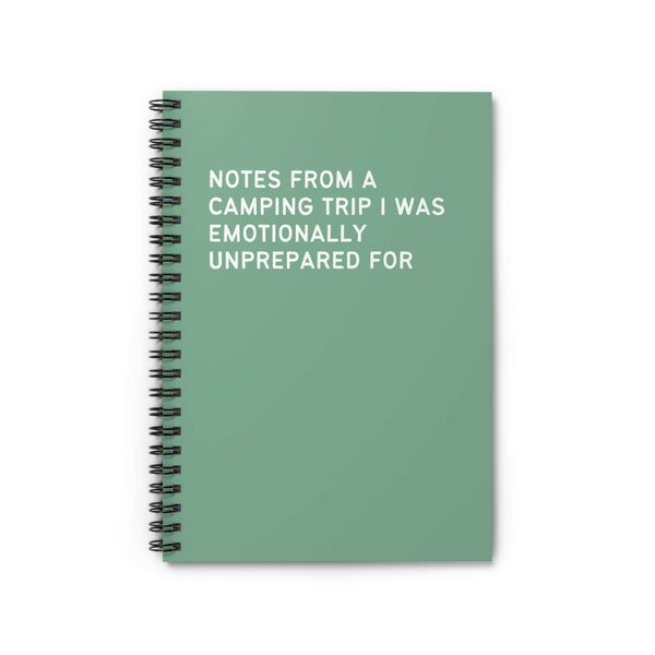 Spiral notebook with the title 'Notes from a Camping Trip I Was Emotionally Unprepared For' on a green cover.