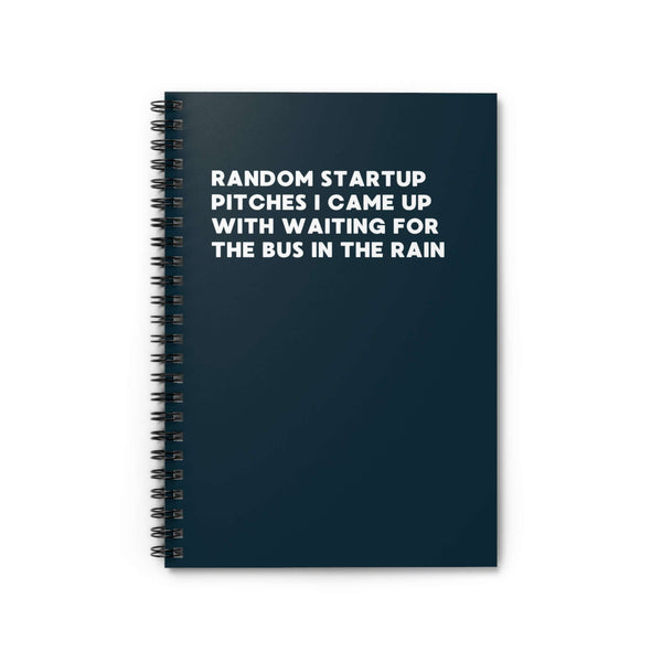 Spiral notebook titled 'Random Startup Pitches I Came Up With Waiting for the Bus in the Rain' on a dark background.