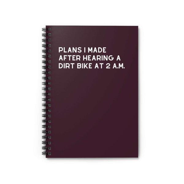 Spiral notebook titled 'Plans I Made After Hearing a Dirt Bike at 2 A.M.' for capturing late-night ideas.