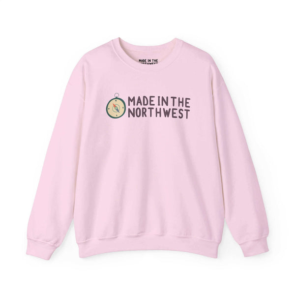 Pink sweatshirt with "Made in the Northwest" logo and compass design, showcasing Pacific Northwest pride and adventure spirit.