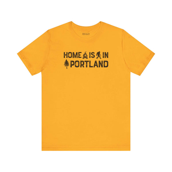 Home Is in Portland Tee – Rose City Pride Shirt with campfire and tree illustrations on yellow fabric.