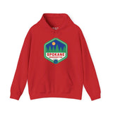 Red Spokane hoodie with retro 90s badge featuring trees, celebrating outdoor beauty and community spirit of Lilac City, Washington.