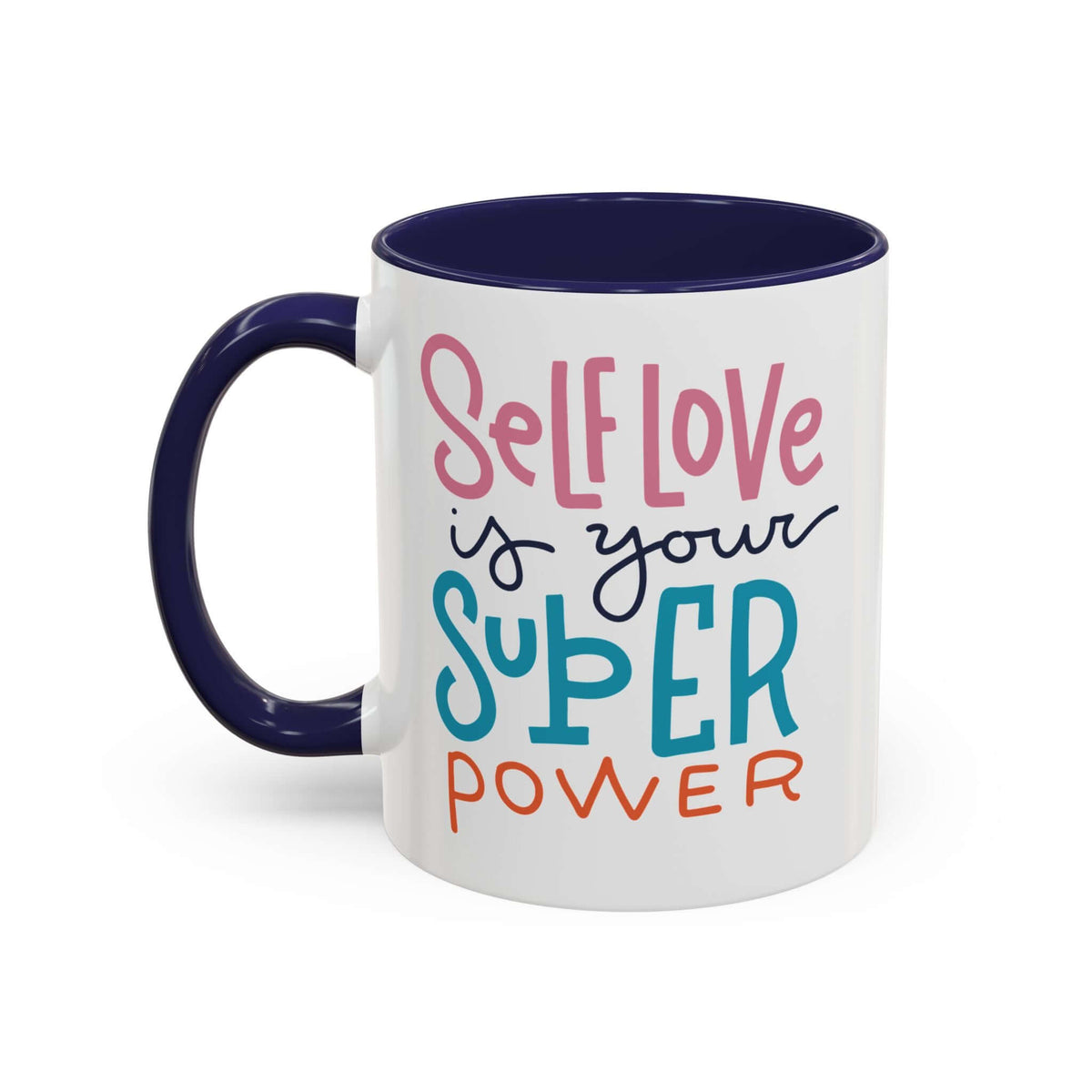 Self Love Is Your Super Power Mug featuring colorful text on a ceramic design with navy interior.