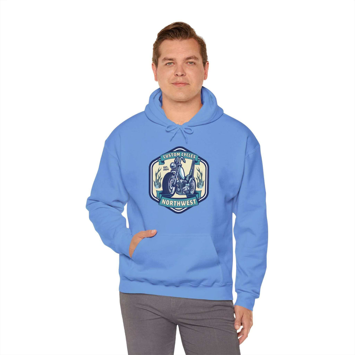 Man wearing blue Custom Cycles Northwest hoodie, featuring a motorcycle design, perfect for motorcycle enthusiasts and casual wear.