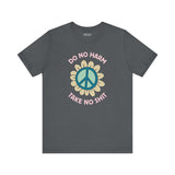 Do No Harm Take No Shit Tee featuring a bold peace flower design on a dark gray t-shirt for positive vibes.