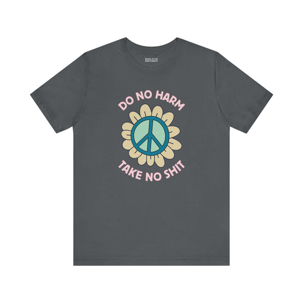 Do No Harm Take No Shit Tee featuring a bold peace flower design on a dark gray t-shirt for positive vibes.