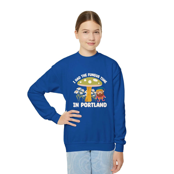 Kid wearing blue sweatshirt with 'I Had the Fungus Time in Portland' design featuring mushrooms and gnome.