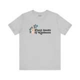 Grey Plant Seeds of Kindness tee featuring a peace sign and blooming flowers, symbolizing positivity and love.