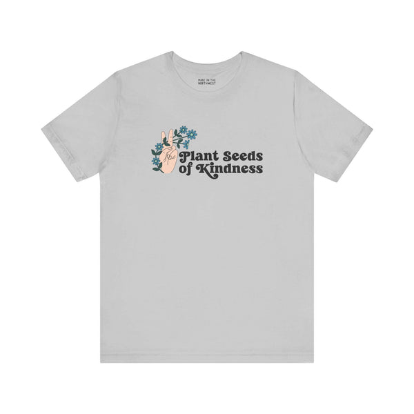 Grey Plant Seeds of Kindness tee featuring a peace sign and blooming flowers, symbolizing positivity and love.