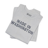 Premium soft tee featuring bold 'Made in Washington' wood log font design, perfect for Pacific Northwest lovers.