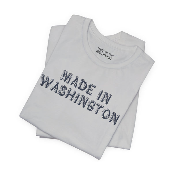 Premium soft tee featuring bold 'Made in Washington' wood log font design, perfect for Pacific Northwest lovers.
