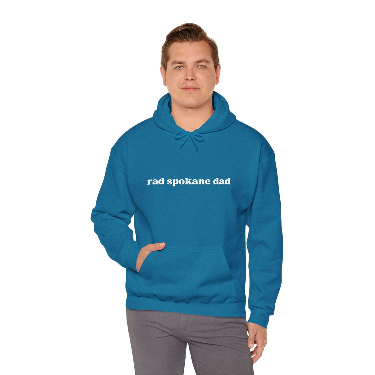 Man wearing a blue Rad Spokane Dad hoodie, perfect for outdoor adventures and casual outings.