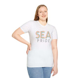 Model wearing a white SEA Pride Rainbow Softstyle T-Shirt, showcasing vibrant city lettering celebrating identity.