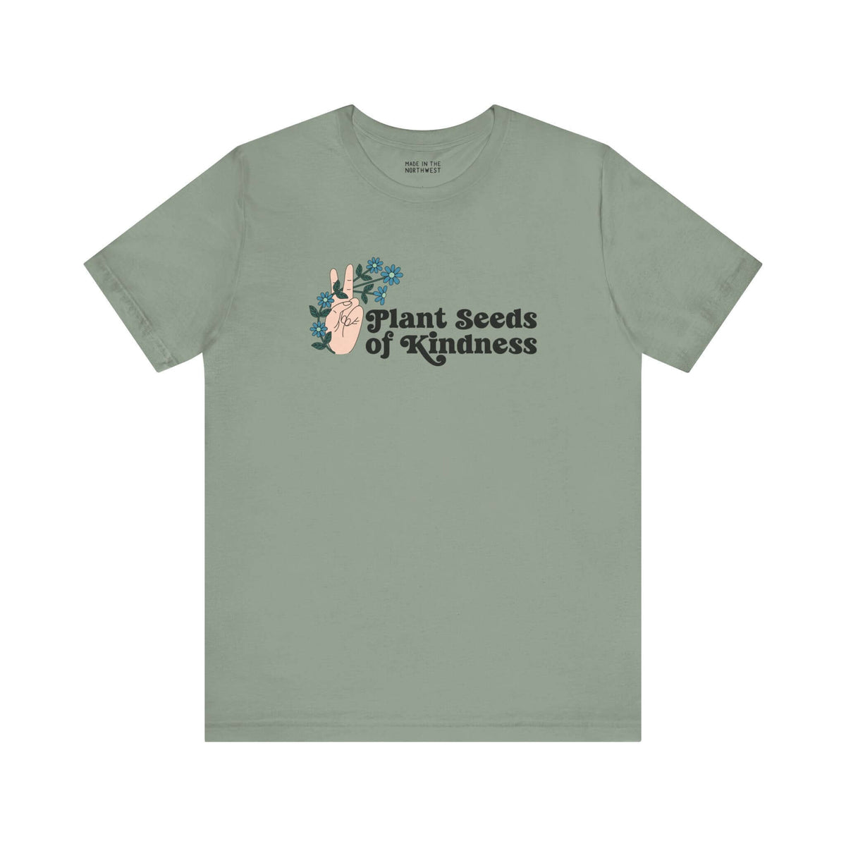 Premium olive green tee featuring 'Plant Seeds of Kindness' design with a peace sign and blooming flowers.