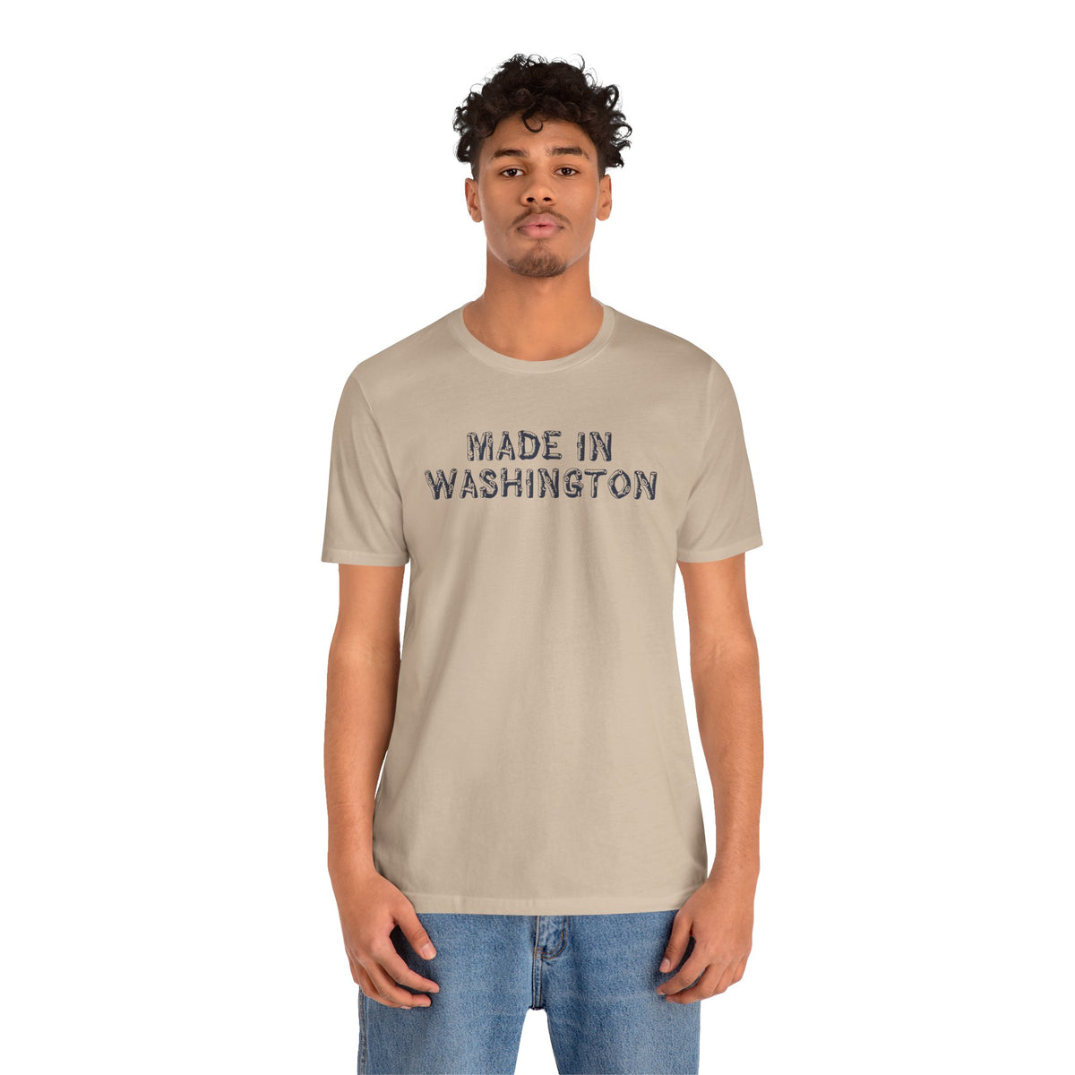 Man wearing a Made in Washington Log Font Premium Soft Tee, featuring bold lettering against a light background.