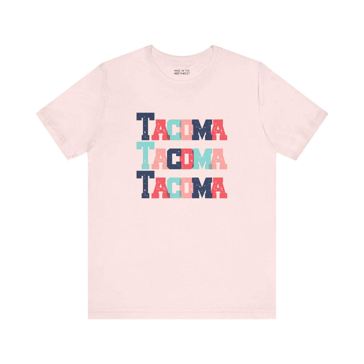 Bold and Bright Tacoma Trio Soft Tee with colorful block-letter city name design on cream fabric.