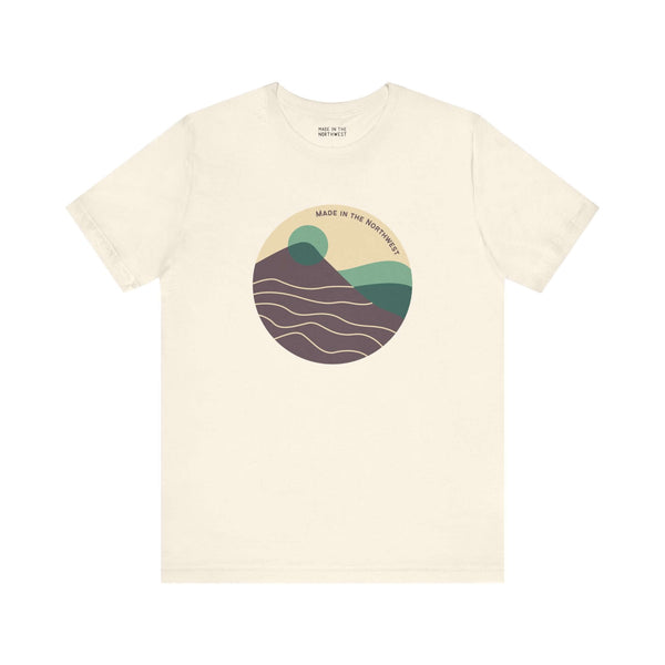 Pacific Peaks Modern Circle Soft Tee featuring a mountain scene in a circle on a neutral background, inspired by the Pacific Northwest.