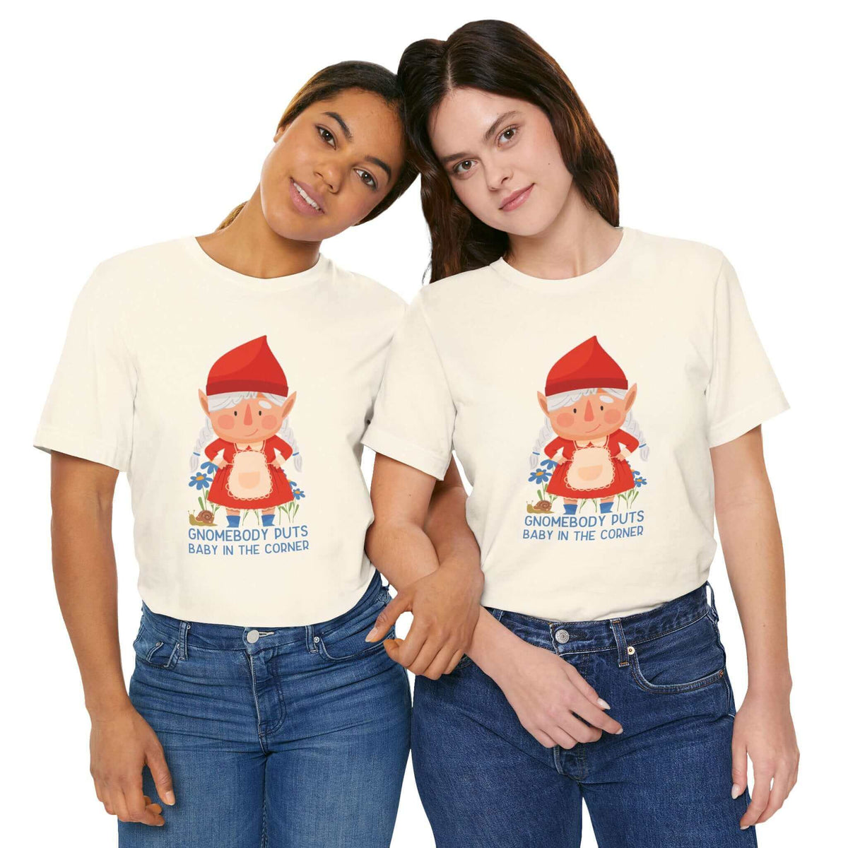 Two women wearing "Gnomebody Puts Baby in the Corner" t-shirts with a whimsical gnome design, standing side by side.