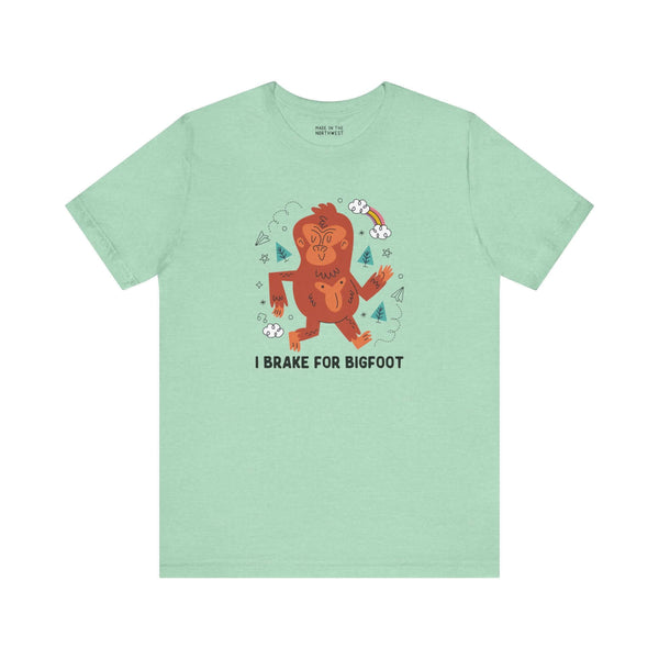 I Brake for Bigfoot Soft Tee Show your playful side and love for local folklore with our "I Brake for Bigfoot" Sasquatch Tee. This fun design features the phrase "I Brake for Bigfoot" alongside a whimsical graphic of a Sasquatch, perfect for those who enj