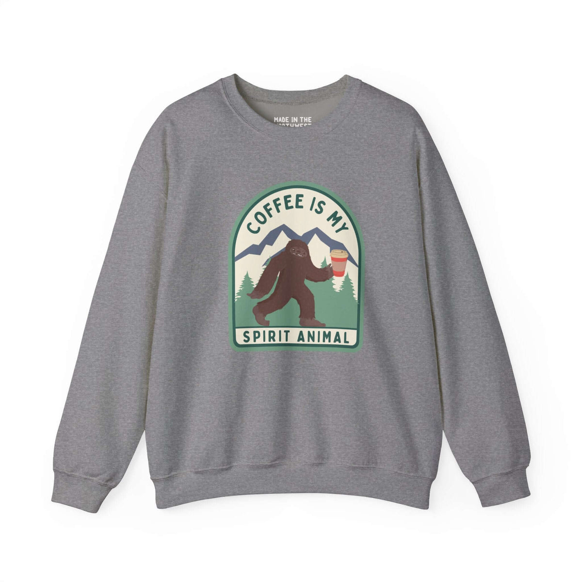 Gray sweatshirt featuring a Sasquatch holding a coffee cup with the phrase "Coffee Is My Spirit Animal" on a forest-themed design.