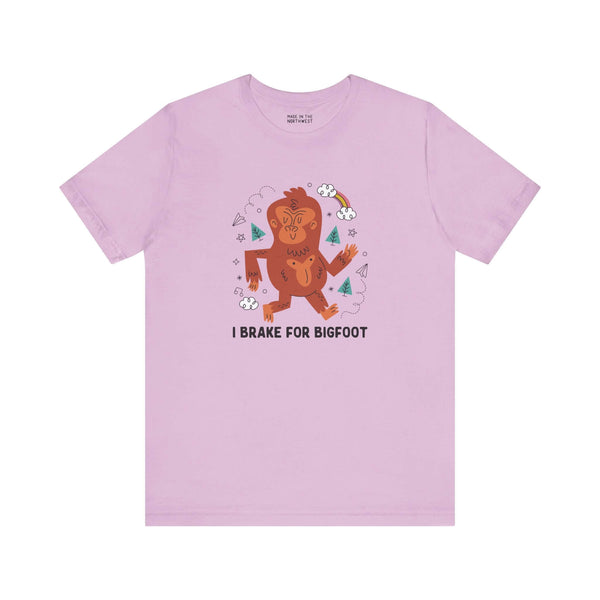 Light pink t-shirt featuring a whimsical Sasquatch graphic and the text 'I Brake for Bigfoot'.