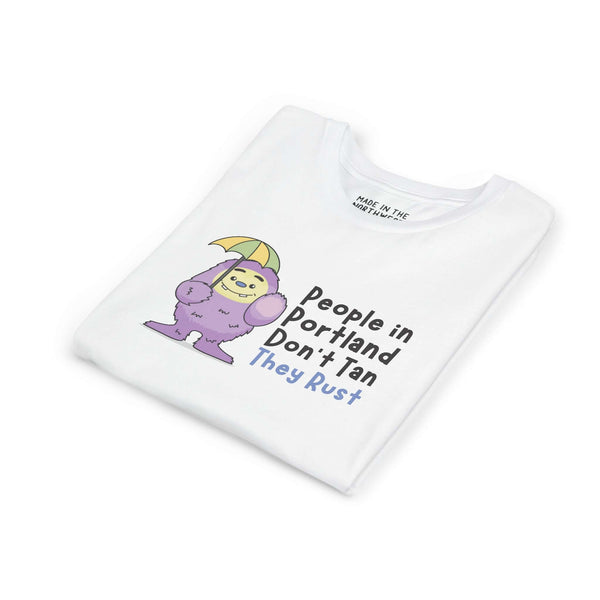 Portland Soggy Monster Kids Heavy Cotton Tee featuring a playful purple creature with an umbrella, perfect for rainy days.