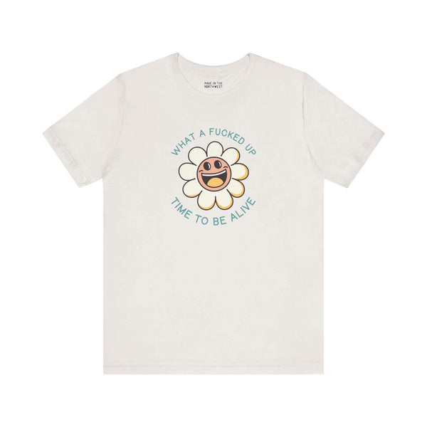 What a F*cked Up Time to Be Alive premium soft tee featuring a smiling daisy design on a light background.