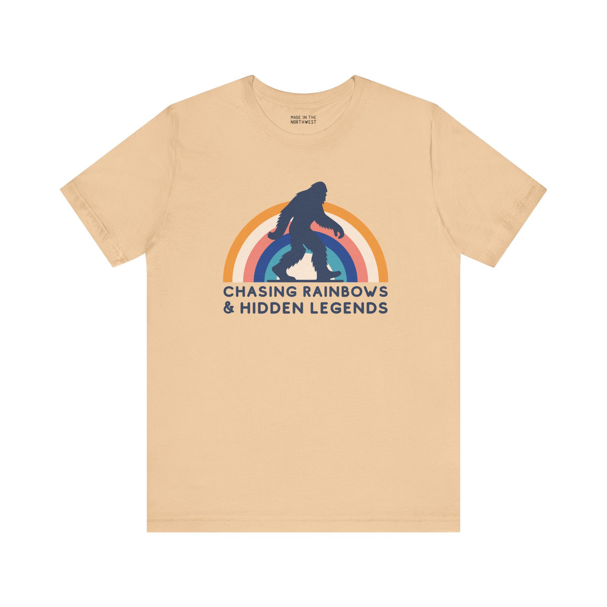 Chasing Rainbows and Hidden Legends soft tee featuring Sasquatch graphic and vibrant rainbow design.