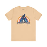 Chasing Rainbows and Hidden Legends soft tee featuring Sasquatch graphic and vibrant rainbow design.