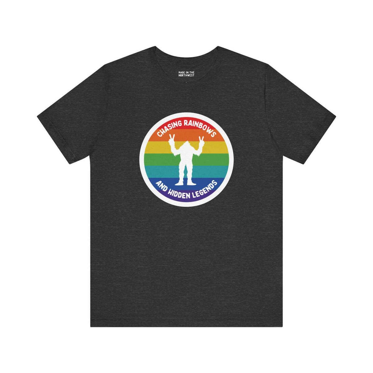 Chasing Rainbows Sasquatch Soft Tee Celebrate your roots with a splash of color and a touch of mystery in our "Hometown Pride" tee. Featuring a vibrant rainbow circle and a playful Sasquatch graphic, this shirt embodies the unique and spirited vibe of the