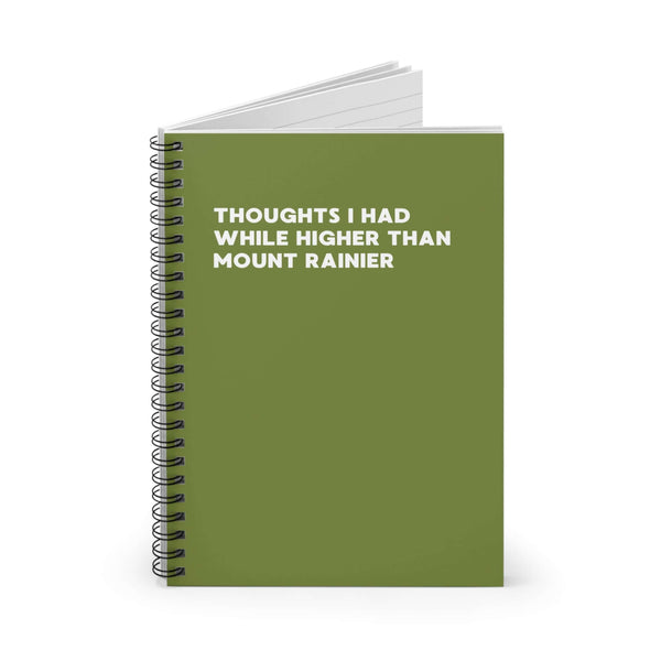 Green spiral notebook with the title 'Thoughts I Had While Higher Than Mount Rainier' on the cover.