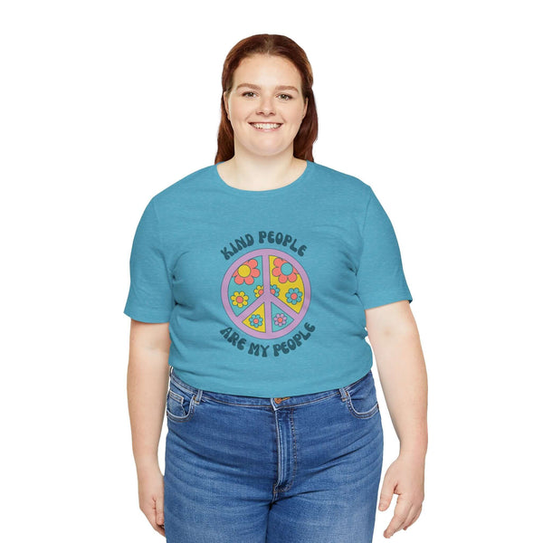 Woman wearing a teal unisex premium tee with a floral peace sign and the text 'Kind People Are My People'.