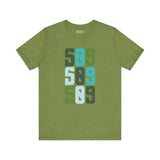 Five-Oh-Nine Pop Premium Soft Tee featuring a stacked 509 design in vibrant greens and blues on a green background.