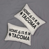 Home is in Tacoma Lumbar Accent Pillow on a gray fabric background, featuring bold text and campfire graphics.