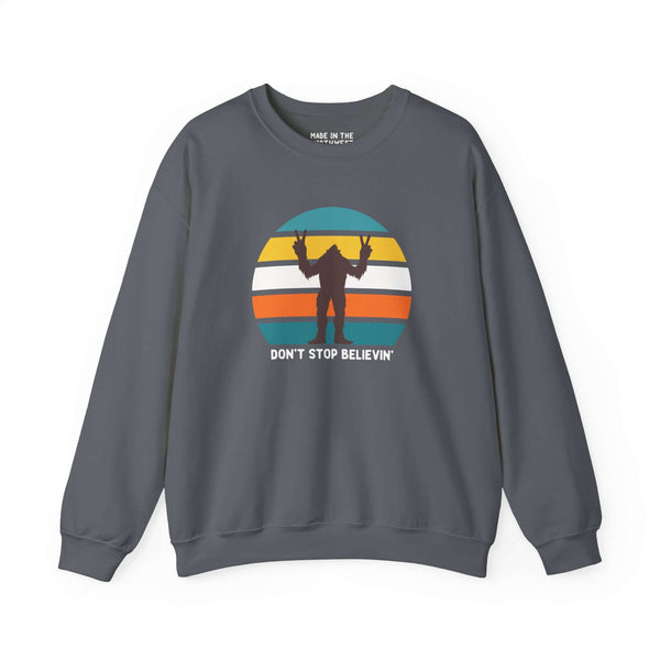Don't Stop Believin' Bigfoot sweatshirt featuring a playful sasquatch graphic and vibrant retro design.