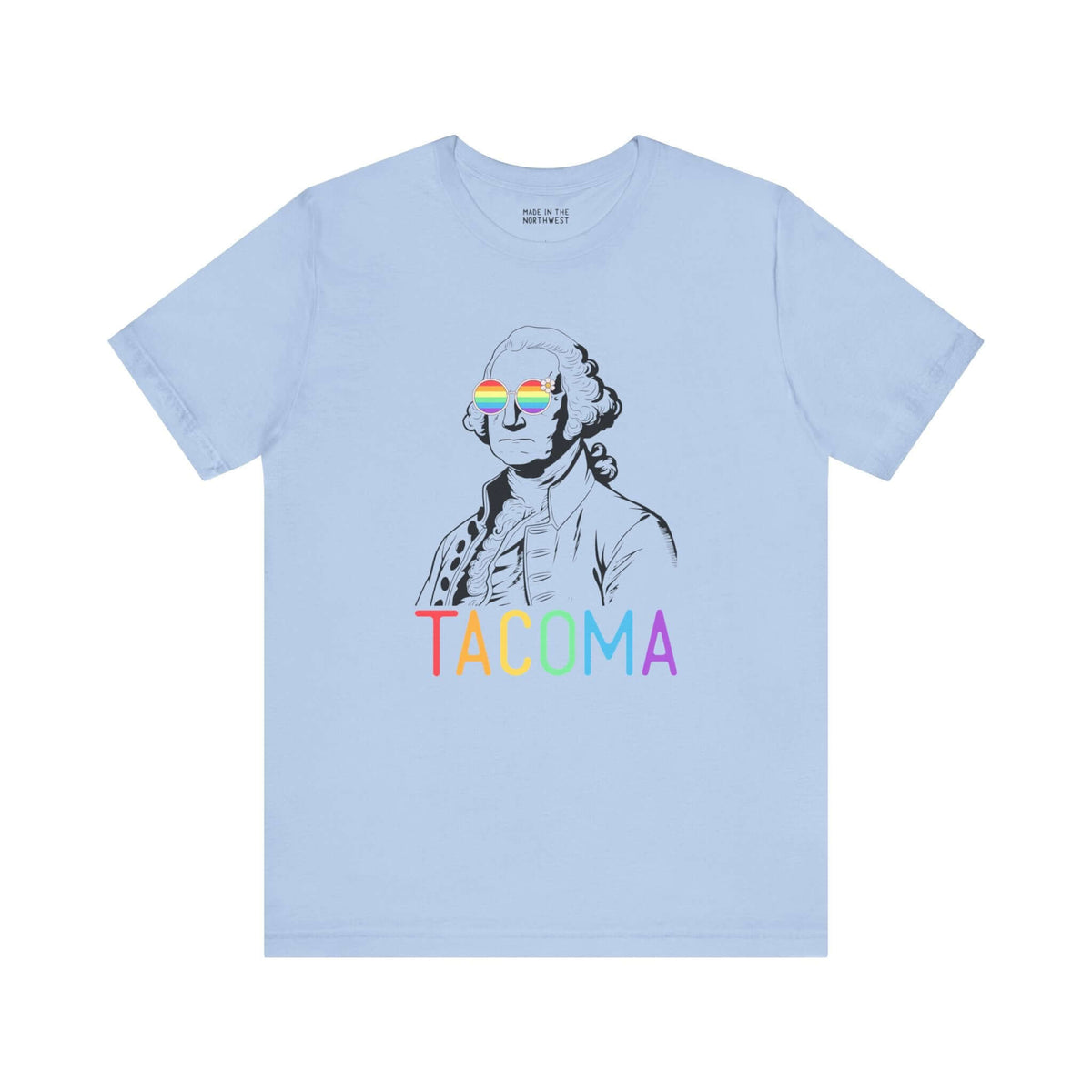 Light blue tee with rainbow "Tacoma" text and George Washington wearing rainbow glasses, symbolizing Pride and inclusivity.