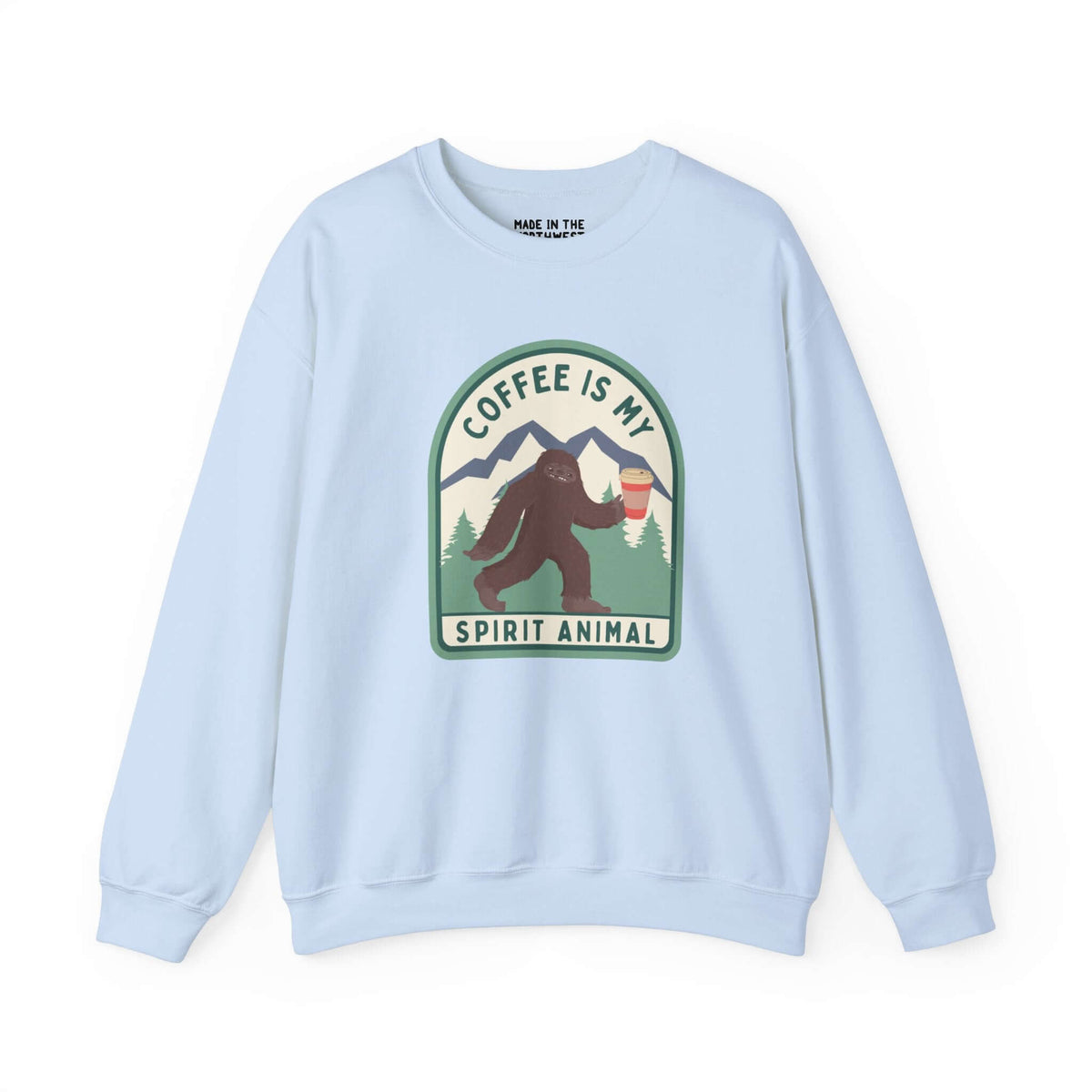 Light blue sweatshirt with Sasquatch design holding coffee and text "Coffee Is My Spirit Animal," perfect for coffee lovers.