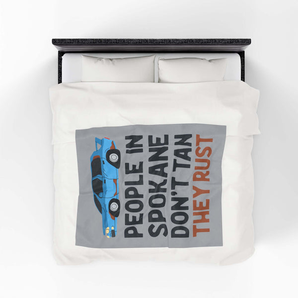 People in Spokane Don't Tan They Rust Lightweight Cozy Blanket on a bed with a vintage car design.