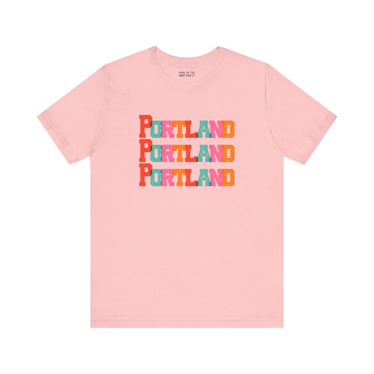 Bold and Bright Portland Trio Soft Tee with colorful block-letter city design on a pink background. Perfect for Rose City fans.