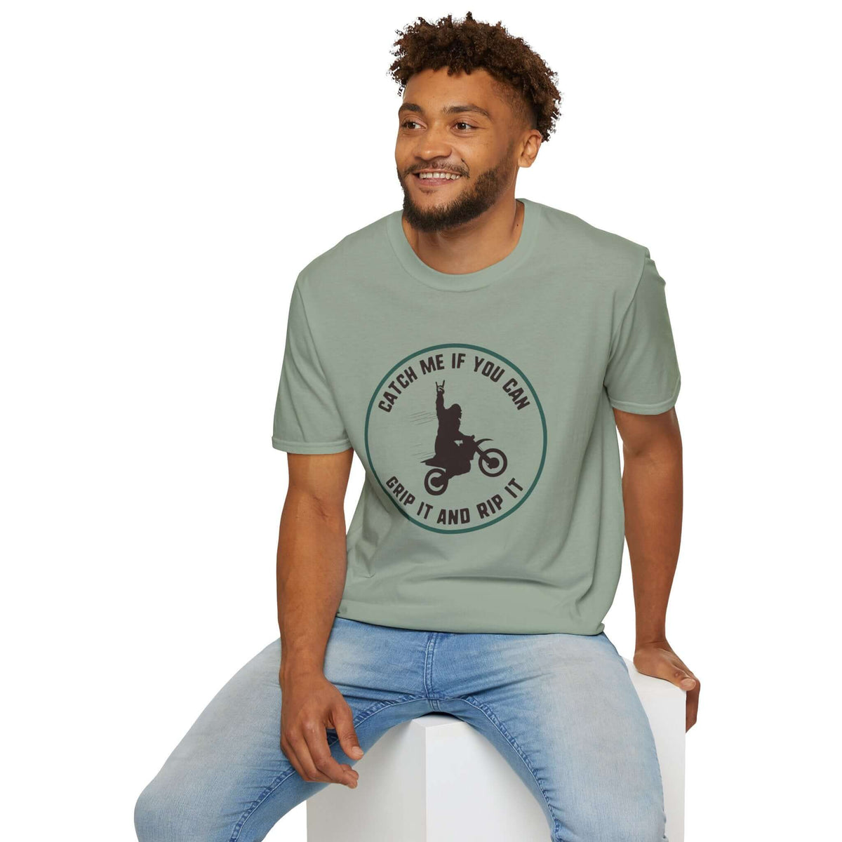 Man wearing a light green 'Catch Me If You Can' Bigfoot motocross T-shirt, showcasing a fun, adventurous design.