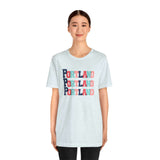 Person wearing a Portland Trio Soft Tee with colorful block-letter design, celebrating Rose City style in a light, comfortable fabric.