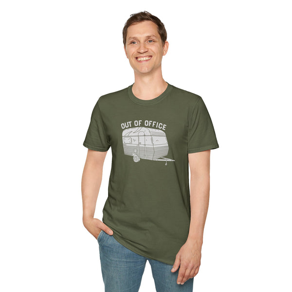 Man wearing Out of Office Camper Softstyle T-Shirt, featuring a retro travel trailer design, ideal for adventure lovers.