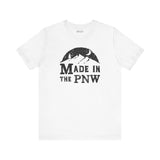 Made in the PNW T shirt featuring a mountain graphic on a white tee, perfect for Pacific Northwest enthusiasts.