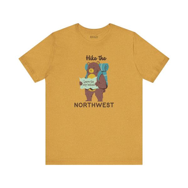 Hike the Northwest t shirt featuring a playful bear with a backpack and map in a soft yellow color.