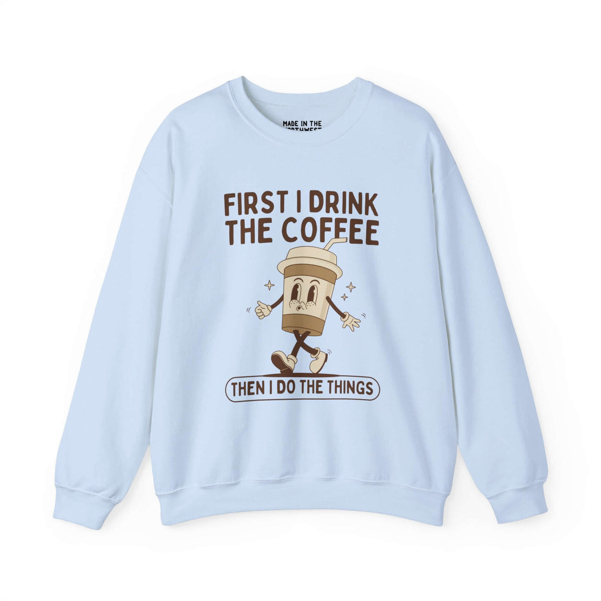 Light blue sweatshirt with "First I Drink the Coffee Then I Do the Things" text and a cartoon coffee cup design. Perfect for coffee lovers.