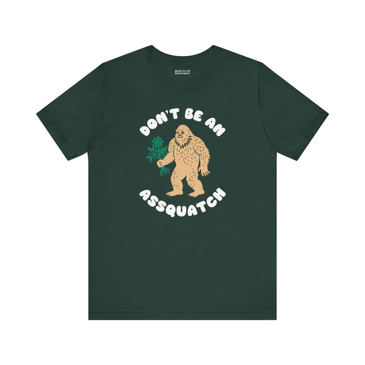 Don’t Be an Assquatch Tee with Bigfoot holding a bouquet on dark green shirt.