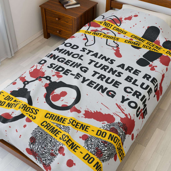 The Crime Scene Snuggle Lightweight Blanket for True Crime Lovers featuring blood stains and crime scene tape.