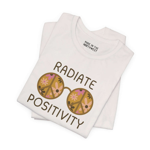 Radiate Positivity soft tee featuring floral sunglasses on a white shirt, promoting kindness and good vibes.