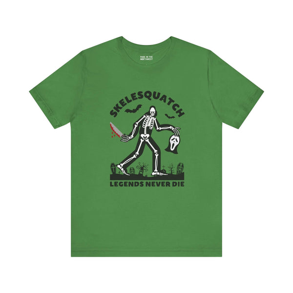 Skelesquatch Legends Never Die Halloween tee featuring skeleton sasquatch with bloody knife and Scream mask on green shirt.